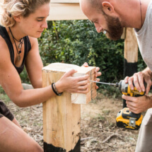 two people building the base of the tiny house